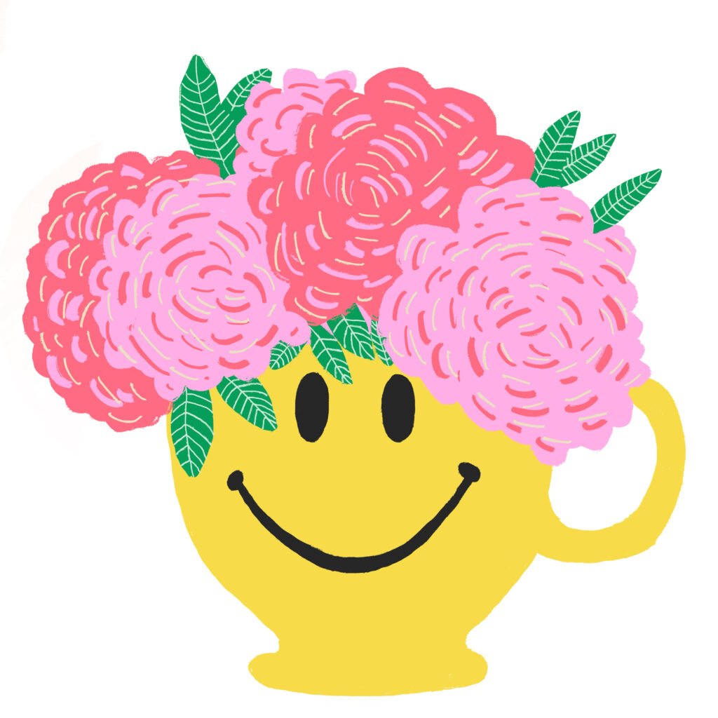 large yellow mug with a smiley face containing pink flowers and greenery blooming out of it